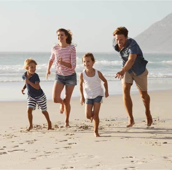 Happy Family On A Beach — Property Lawyers In Central Coast, NSW