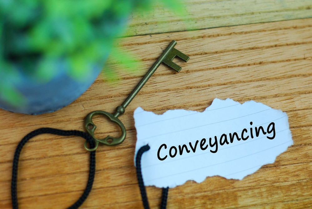 Key And Torn Paper With Text Conveyancing